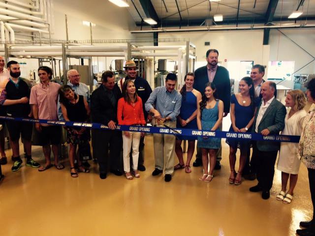 Owner Jerry Perez cuts the ribbon during the Grand Opening Ceremony